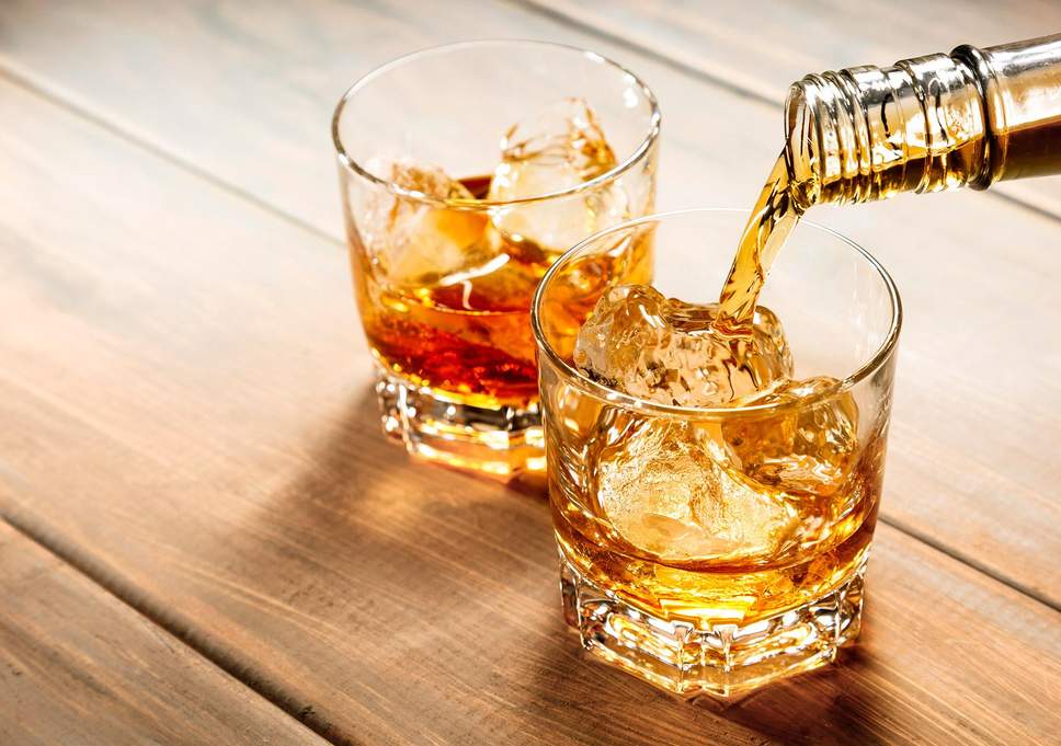 pouring whiskey into glass