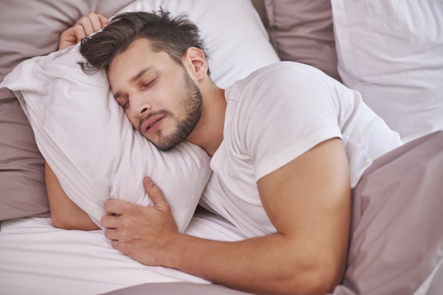 man sleeping in bed