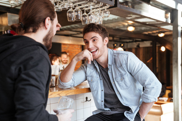 Man talking with his friend in the bar 
