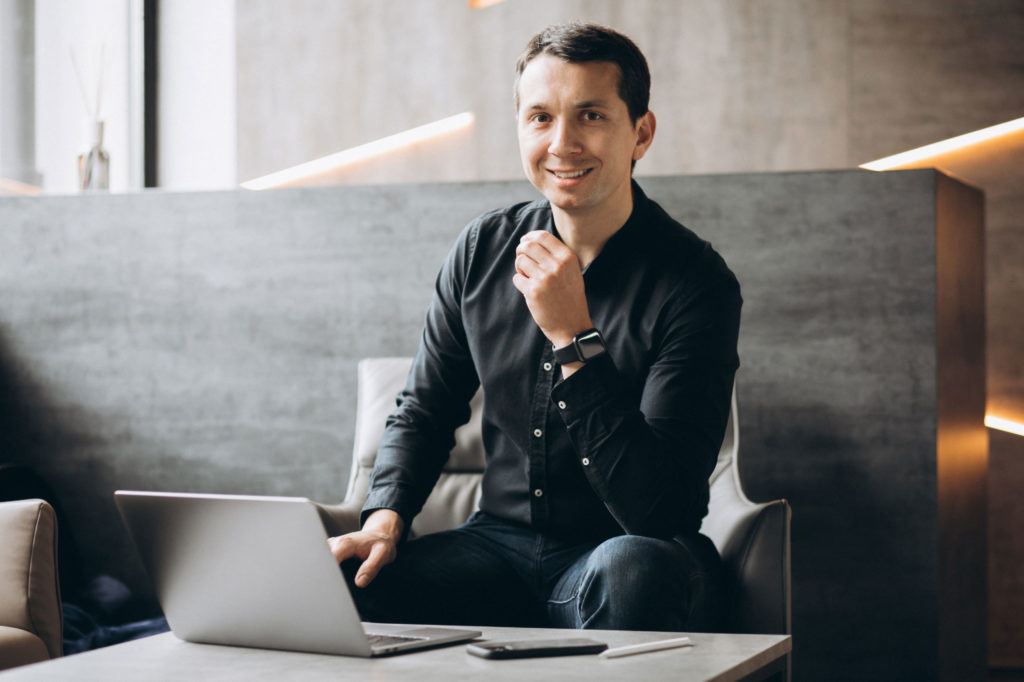 Handsome business man working on computer in office