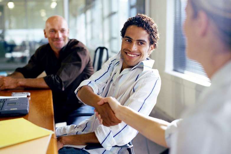 smilling man and woman shaking hands