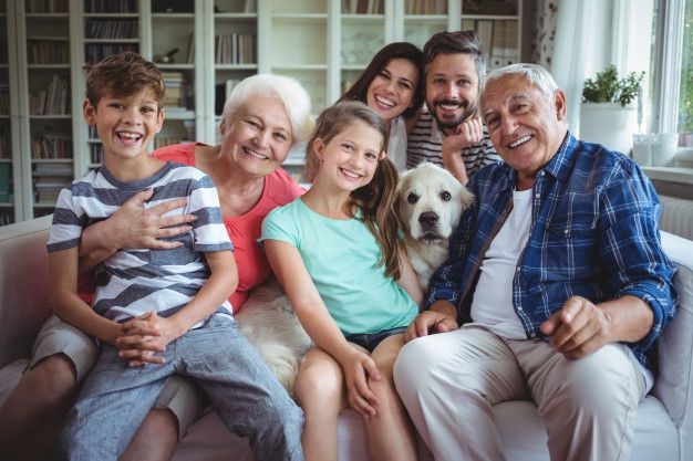 happy family sitting on sofa in living room 
