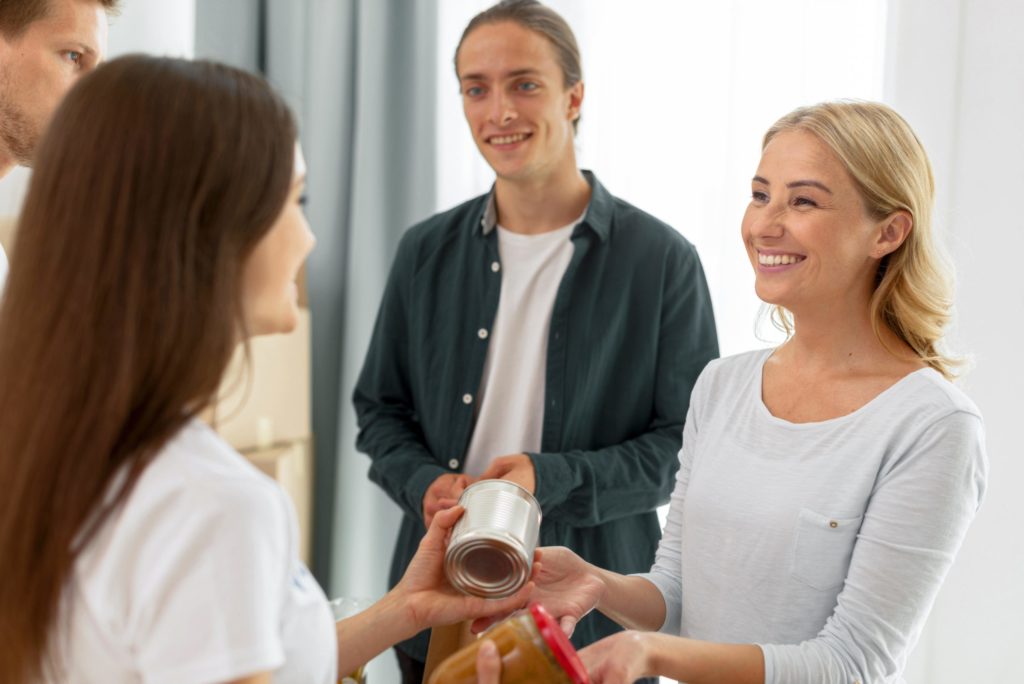 Cheerful volunteers giving out food donations 