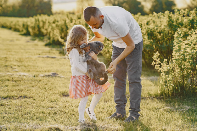 Family with little daughter spending time together in sunny