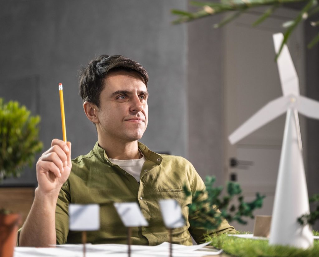 man thinking about an eco-friendly wind power project with wind turbines