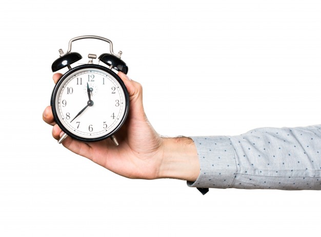 man holding a clock - time management- successful lifestyle
