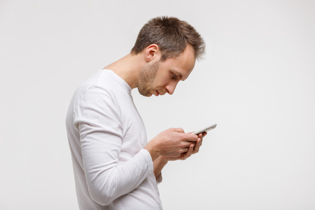 man using phone with bad posture