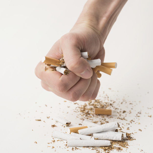 man's fist creasing cigarettes