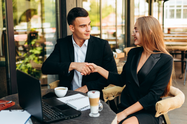 Man and woman shake hands. business deal