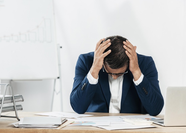 stressed man looking paper