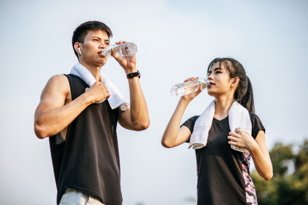 man and woman drinking water; healthy lifestyle