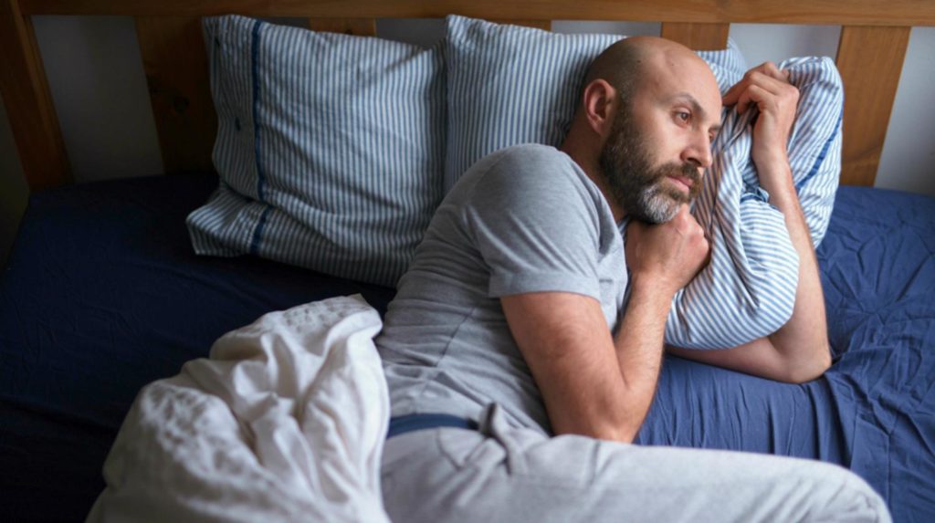 Man can't sleep in bed suffering insomnia