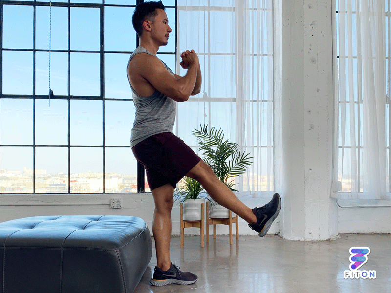 man doing pistol squat at home