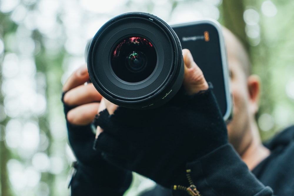 Young man is taking picture with camera