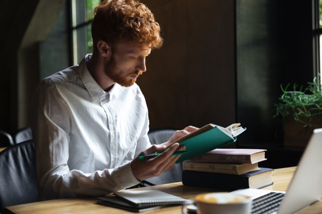 student preparing for university exam in a cafe