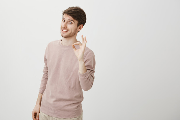 man showing ok gesture - travelling is good for health