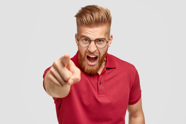 bearded guy with ginger trendy hairstyle, yells angrily at somebody