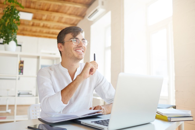 Portrait of happy pensive young businessman wears white shirt at the office