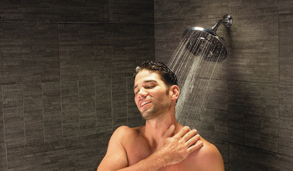 man taking bath in shower