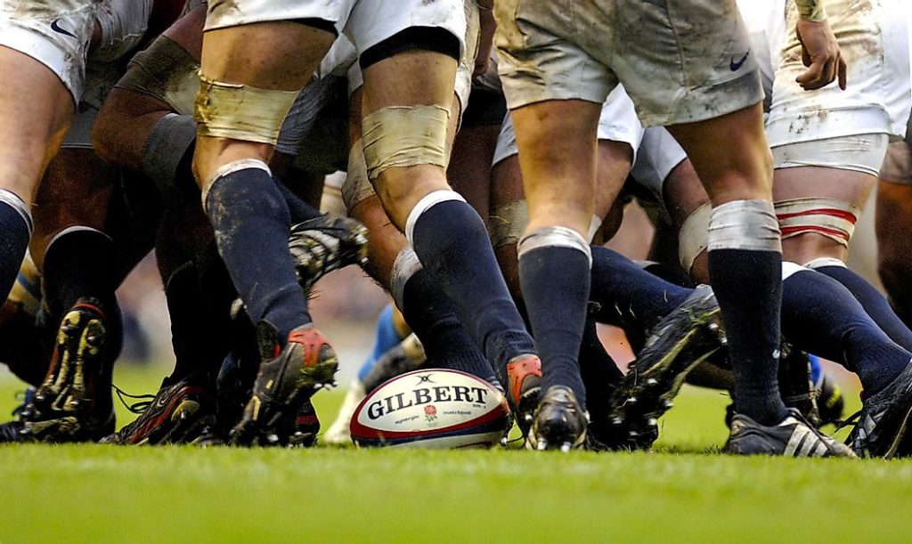 rugby players scrum during a game