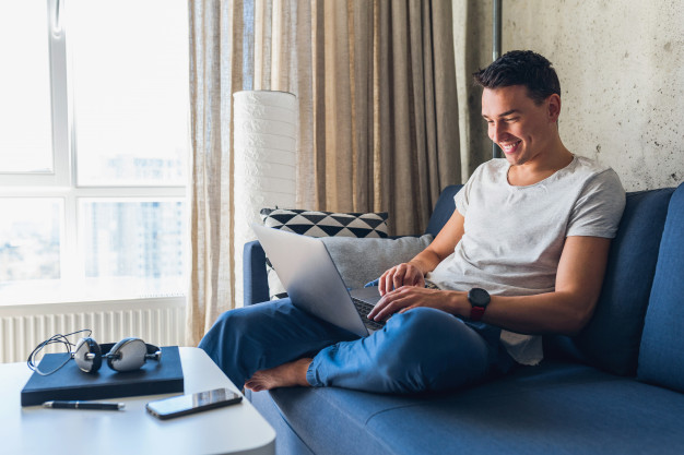 Man Happily Typing at Computer