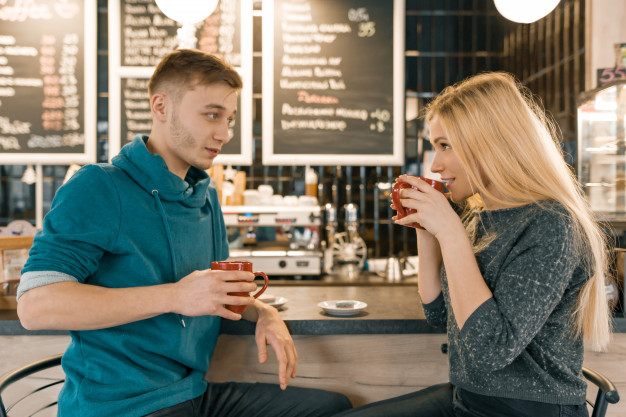 young-smiling-man-woman-together-talking-coffee-shop
