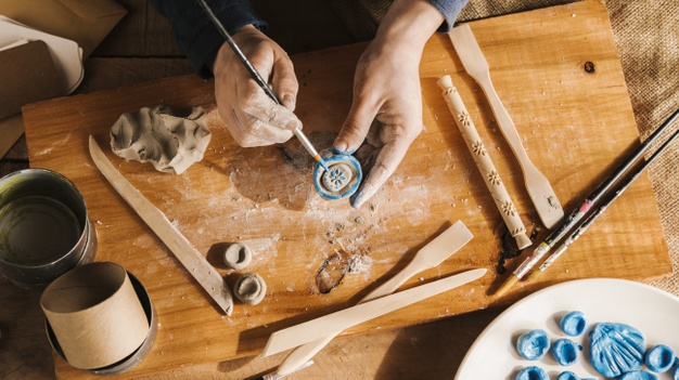 High angle man carving art pieces