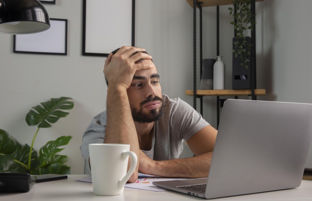 Man feeling bored while working from home