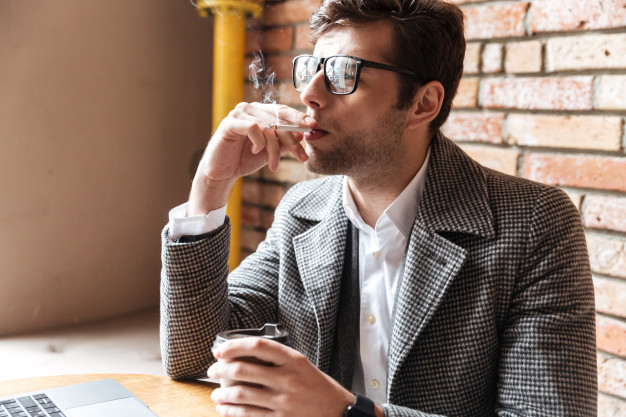 a person puffing on a cigarette surrounded