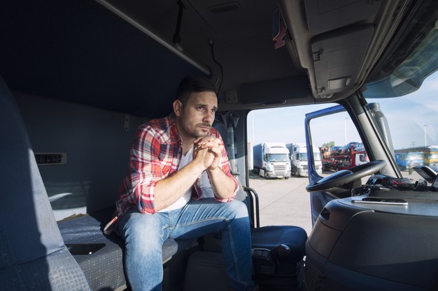 Truck driver sitting in his cabin and thinking about his family