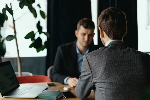 men working at laptop during a meeting in a cafe 