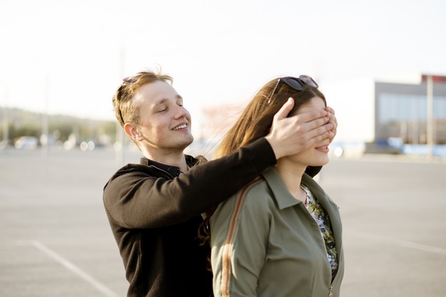 young couple family cover eyes and make surprise outdoors, happy romantic love concept
