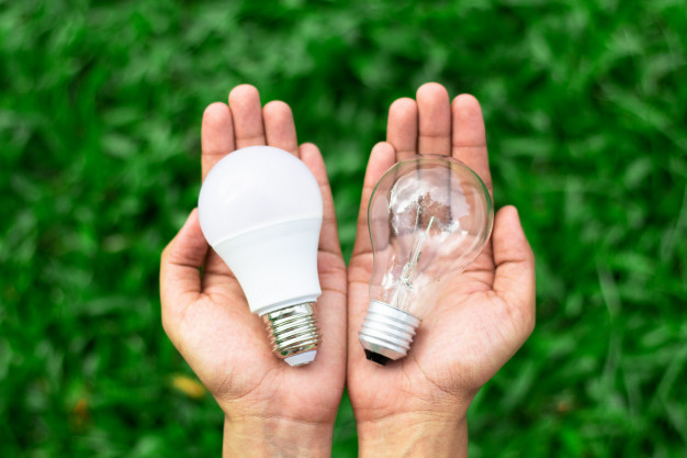 alternative-technology-concept-hands-holding-led-bulb-fluorescent-bulb-comparing