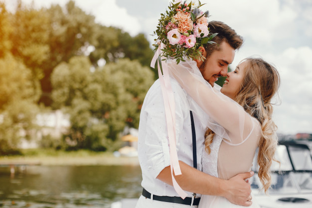 Beautiful bride with her husband in a park 