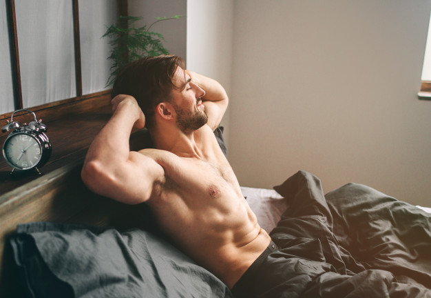 carefree-guy-enjoying-new-day-sexy-happy-bearded-man-bed