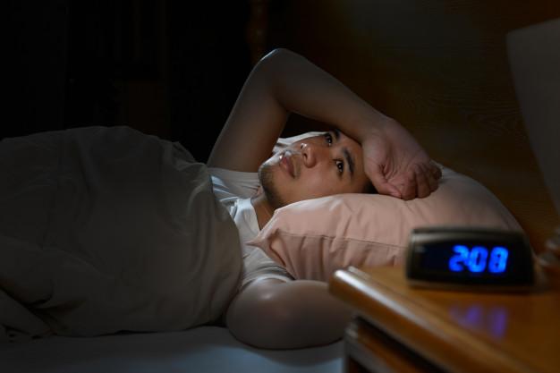 depressed-man-suffering-from-insomnia-lying-bed