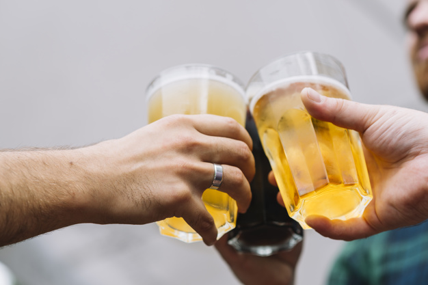 friend-s-hand-toasting-glass-beer