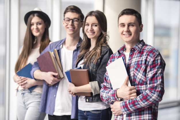 Group of happy young students in a university
