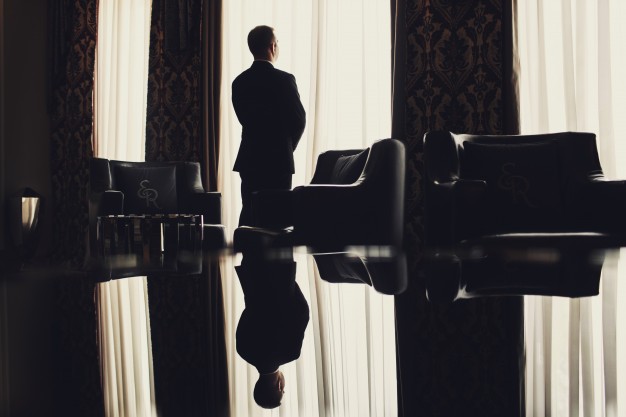 man stands before the window in a room