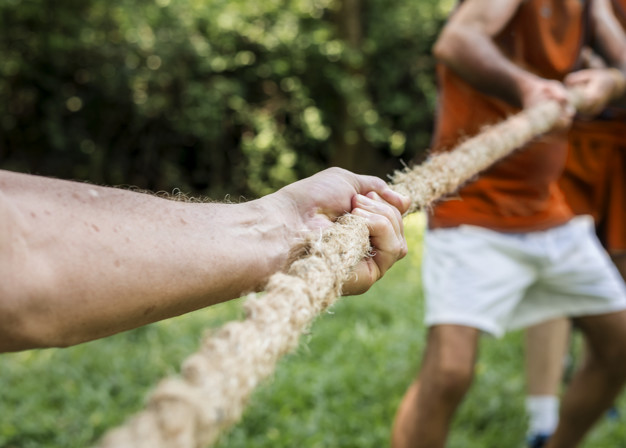 Mature people in tug of war