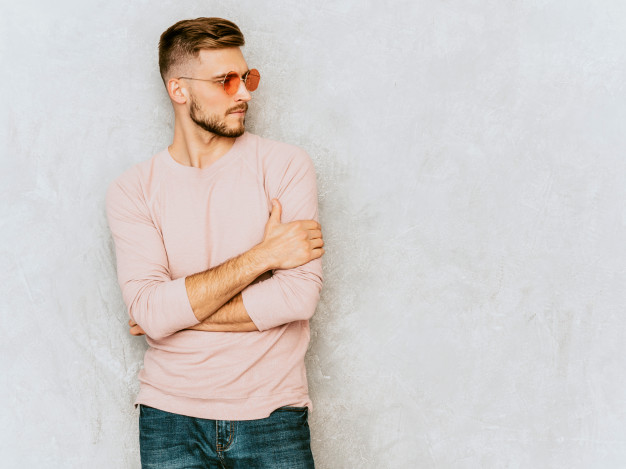 handsome smiling young man model wearing casual summer pink clothes.