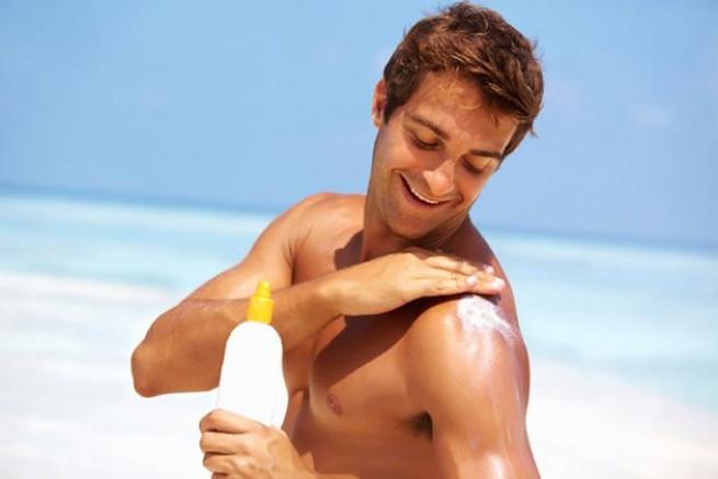 man applyign sunscreen; happy lifestyle