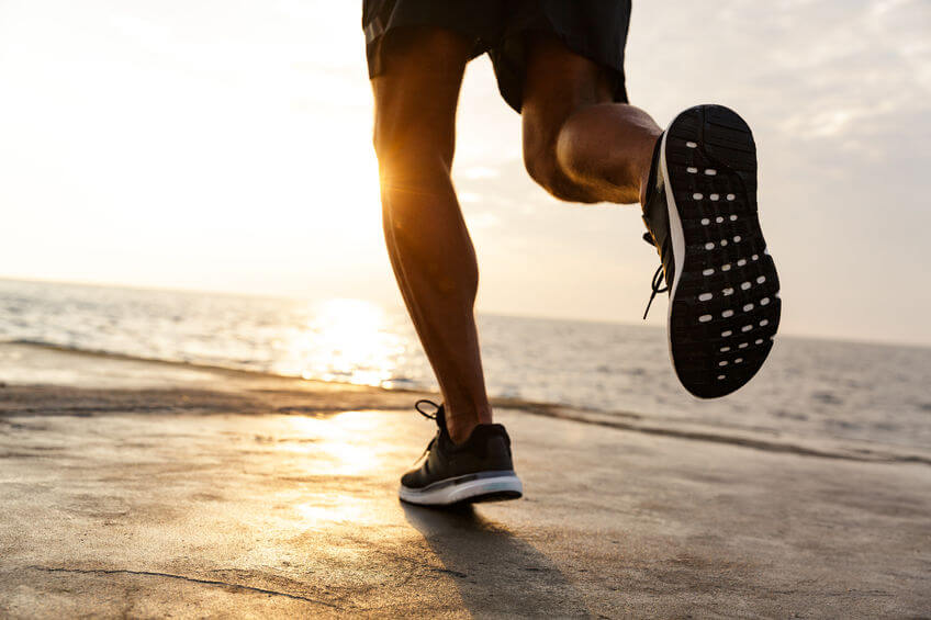 man running along the sea