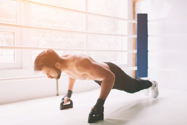 side-view-concentrated-boxer-with-naked-torso-doing-push-ups-boxing-ring
