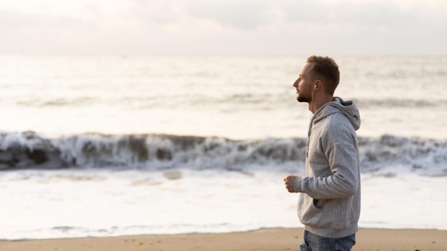 side-view-man-jogging-beach