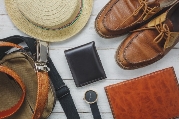 top-view-accessoires-travel-with-man-clothing-concept-wallet-wooden-background-watch-bag-hat-notebook-shoe-white-wood-table