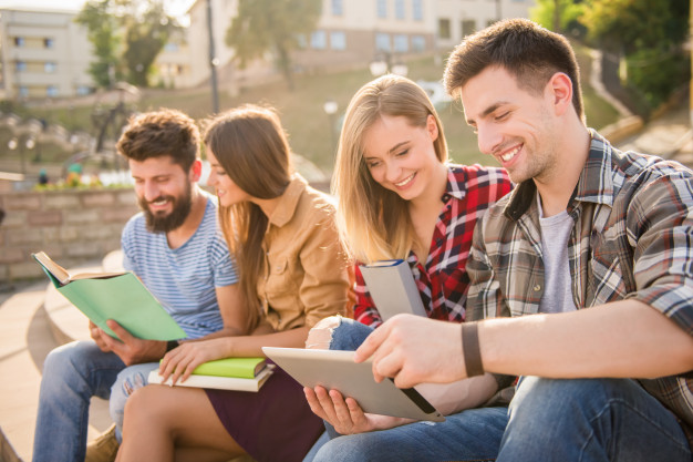 Two beautiful couples read books and spend time together