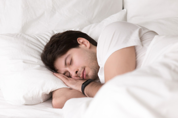 young-guy-sleeping-bed-wearing-smartwatch-sleep-tracker