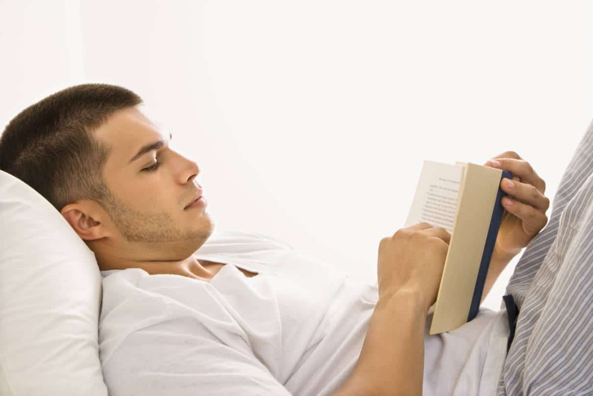 man reading on bad; bad habits for men