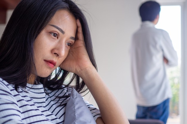 sian woman is stressed and anxious about the love problems between her husband after an intense quarrel